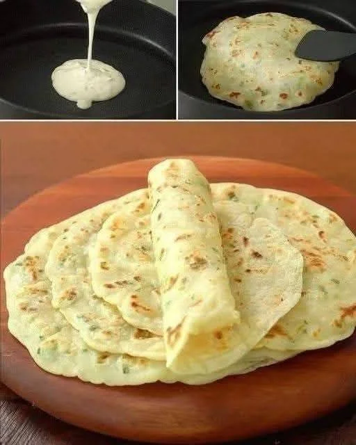 Homemade garlic flatbread garnished with herbs on a wooden board