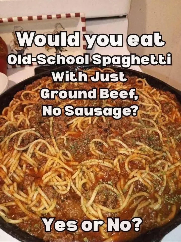 Plate of spaghetti with ground beef garnished with parsley.